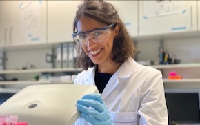 Lang looks at camera while working in the lab.