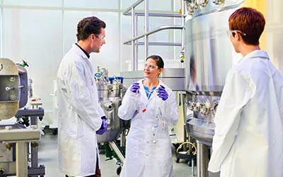 Three scientists in a lab. Three scientists in a lab.