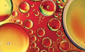 Extreme close-up of detergent bubbles in different sizes