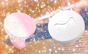 Pink tablets in the process of being coated with a white film coating.