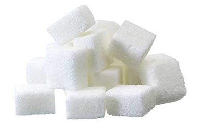 A pile of white sugar cubes neatly stacked against a plain white background. The cubes are uniform in size and shape, suggesting a sense of order and simplicity. The image highlights the granular texture of the sugar cubes.