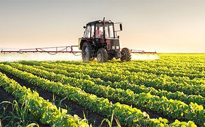 In this image we can see a tractor over the farm where they are doing a farming procedure.
