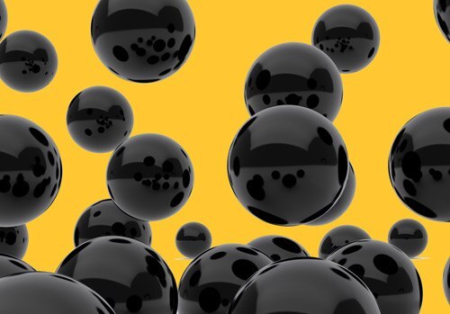 Carbon adsorbents, depicted as shiny black spheres of various sizes against a yellow background, representing the porous structure utilized in filtration and purification processes.
